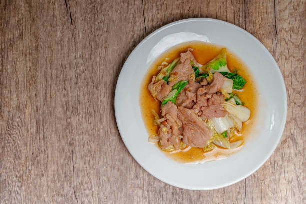 istock Stir Fried Cabbage with Pork in a White Plate 1409430581
