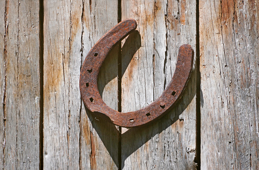 Old rusty horseshoe on a pine board. Natural wood background. Place for text.
