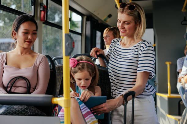 istock Girl doing homework with mom in public transport 1409431375