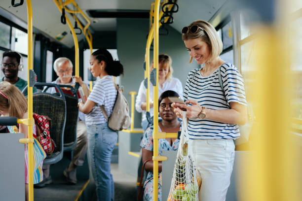 istock Caucasian woman with groceries texting on bus 1409431384