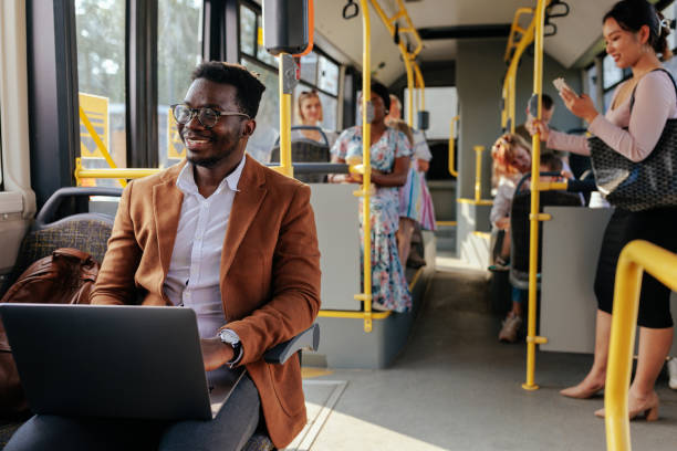 istock Young african american man working on laptop in bus 1409431386
