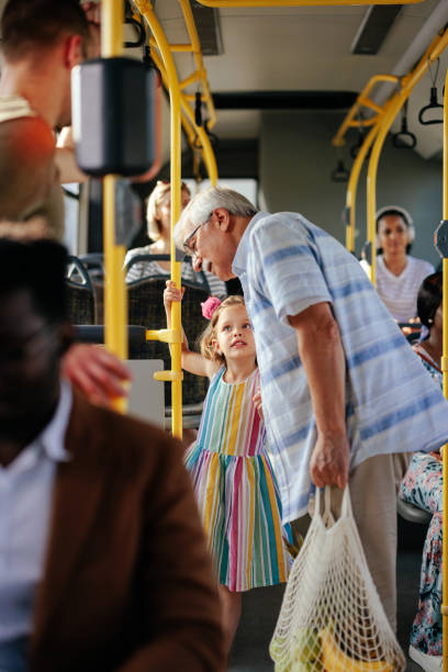 neta viajando com avós de ônibus - generation gap multi generation family vertical holding hands - fotografias e filmes do acervo