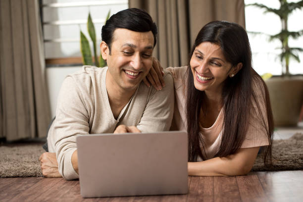 istock Couple having fun using laptop at home 1409431692