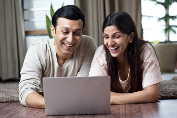 istock Couple having fun using laptop at home 1409431709