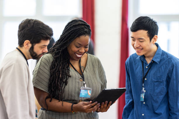 istock Multiracial business team discussing using a digital tablet at a conference event 1409432845