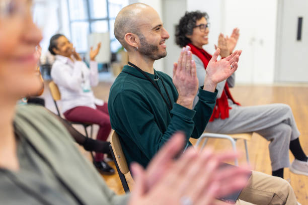 group of businesspeople clapping hands after a successful training session - training business seminar clapping imagens e fotografias de stock