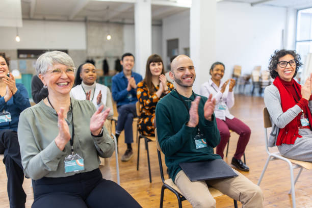 istock Businesspeople applauding good presentation in office 1409432922