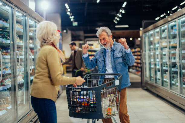 istock Happy senior couple with cart 1409433690