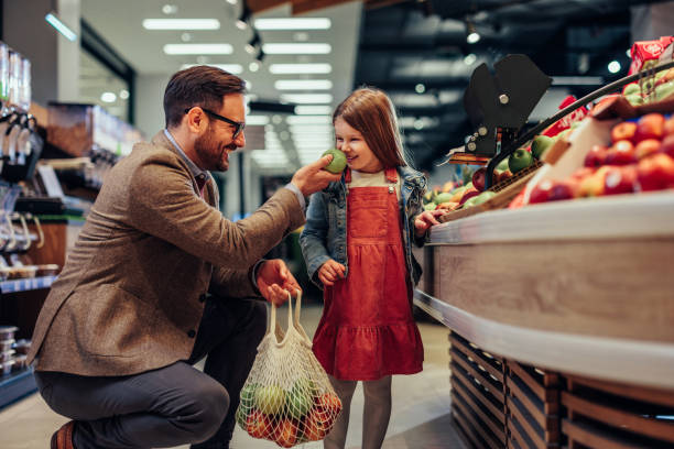 istock Cute single father and his daughter in shopping 1409433703