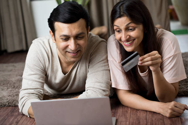 istock Couple using laptop for online shopping at home 1409434532