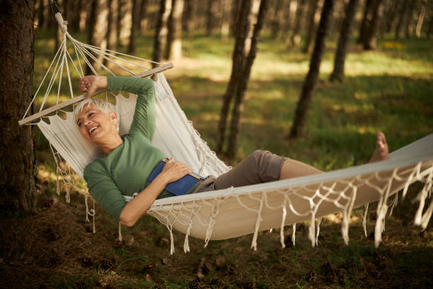 istock Happy senior woman enjoying in hammock. 1409437489