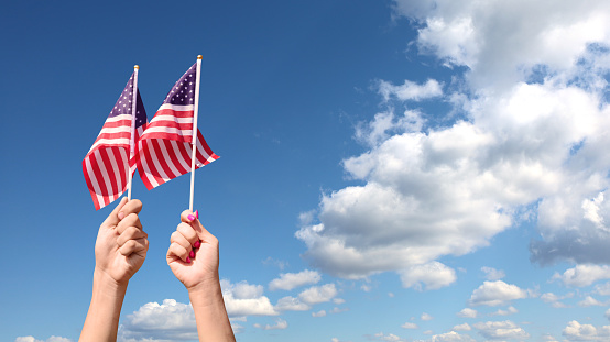 American flags on sky background. Independence Day concept. USA holiday.