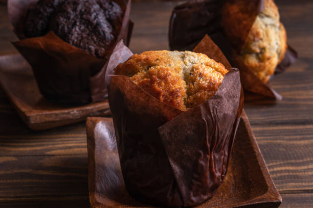 istock Muffins on wooden plate on wooden background 1409438440