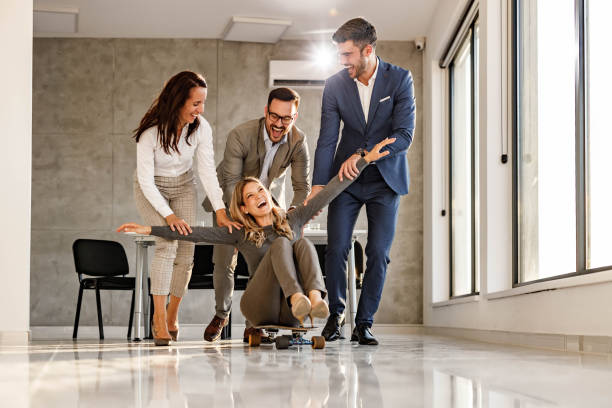 istock Playful business people having fun in the office. 1409438738