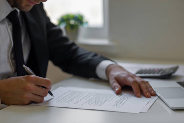 man signing contracts - endorsing business application form filling imagens e fotografias de stock