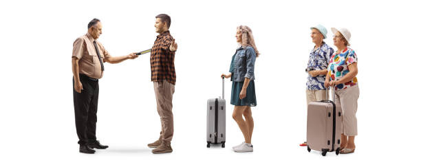 istock Full length profile shot of a security guard checking passengers with a scanner 1409441098