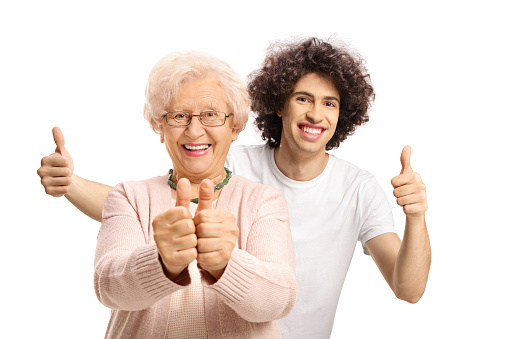 Happy guy standing behind an elderly woman and gesturing thumbs up isolated on white background