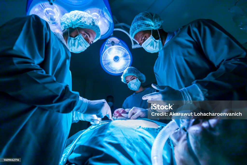 Team of surgeon doctors are performing heart surgery operation for patient from organ donor to save more life in emergency surgical room Team of surgeon doctors are performing heart surgery operation for patient from organ donor to save more life in the emergency surgical room Surgery Stock Photo