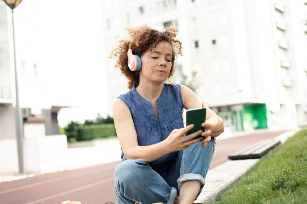 istock Beautiful student enjoying music outdoors 1409444389
