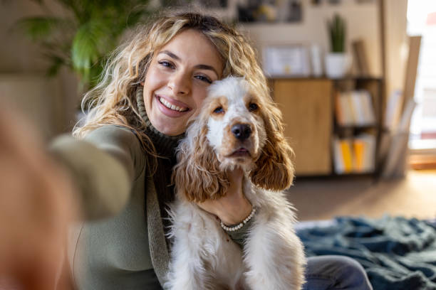 istock Young Caucasian woman taking selfie with her Cocker Spaniel dog 1409447100