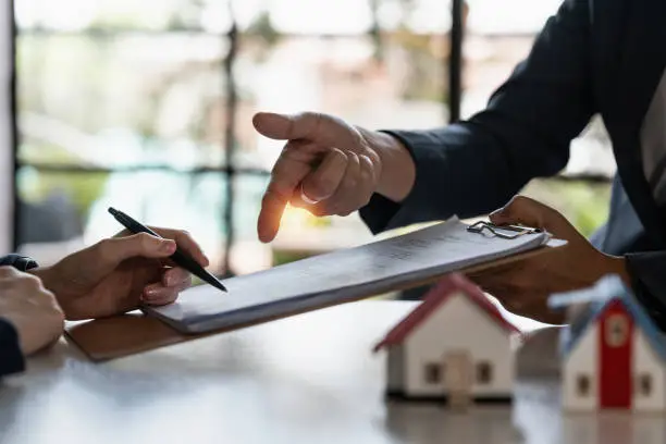 Photo of Real estate concept. Businessman pointing at agreement contract.