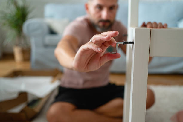 istock Close up of unrecognizable Caucasian man assembling the chair 1409447635