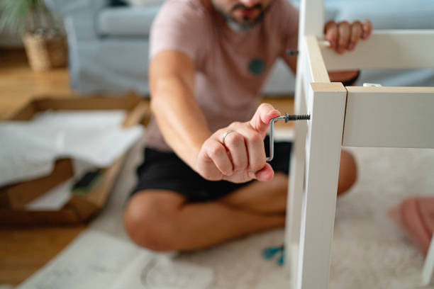 istock Close up of unrecognizable Caucasian man assembling the chair 1409448175
