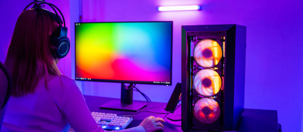 istock Asian professional gamer playing online video game on desktop computer PC have colorful neon LED lights 1409448589