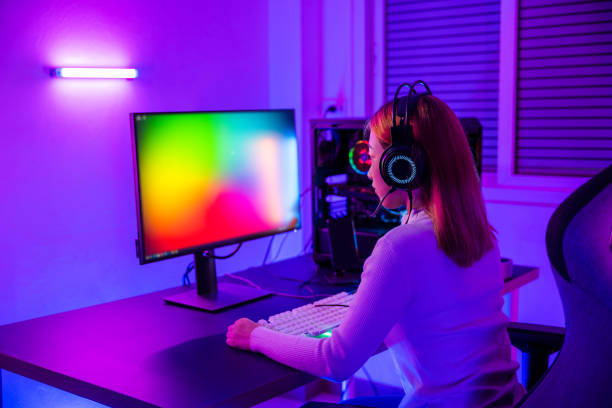 istock Asian professional gamer playing online video game on desktop computer PC have colorful neon LED lights 1409448590