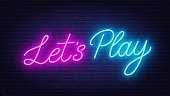 istock Let's Play neon sign on brick wall background. 1409449909