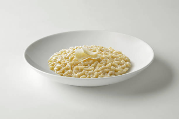 istock Cheese Risotto and parmesan flakes in white bow 1409450631