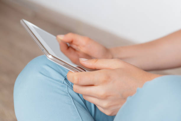 istock woman holding digital tablet, closeup 1409450822