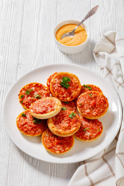 istock mini pizzas with ham and pecorino cheese, top view 1409452056