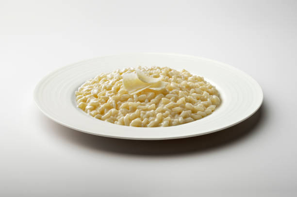 istock White dinner plate with cheese risotto and parmesan flakes 1409452251