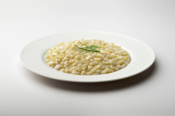 istock White dinner plate with parmesan cheese risotto and chives 1409452317