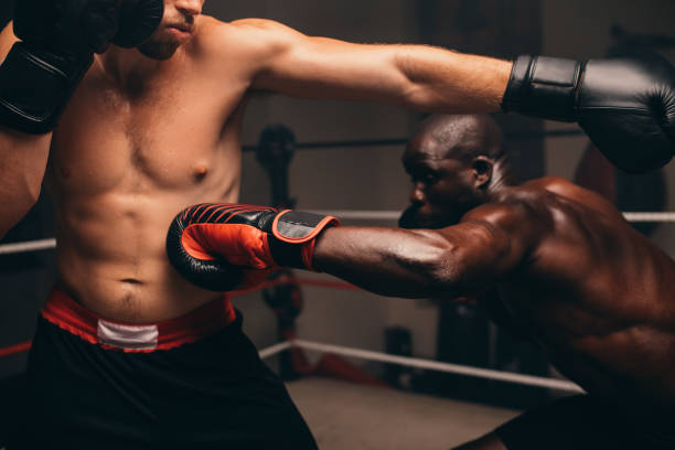 istock Nimble black athlete striking his challenger in a fight 1409452329