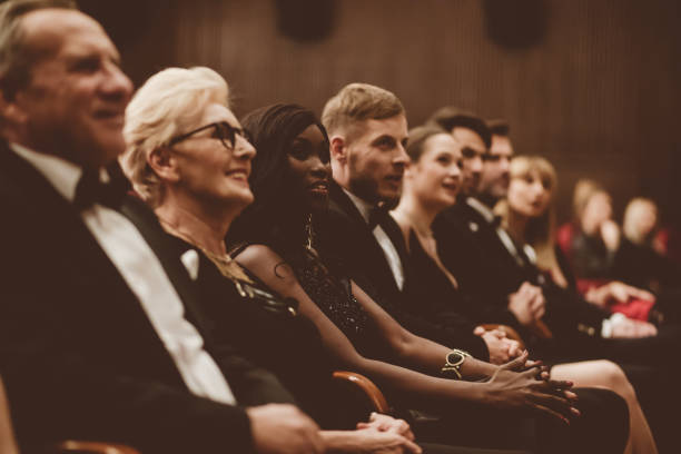 istock Smiling spectators sitting in the theater 1409455014