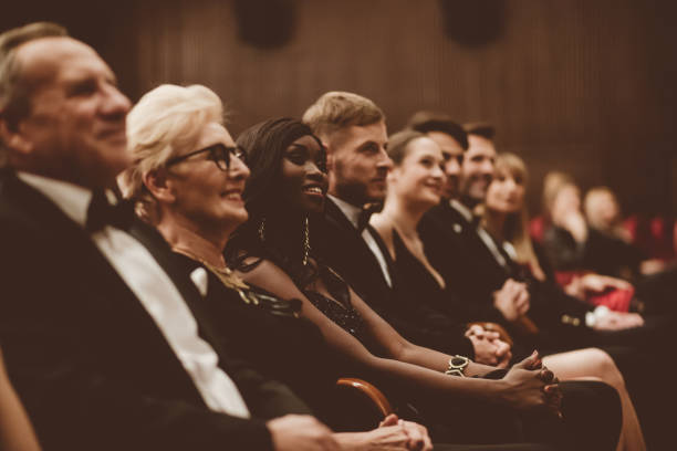 istock Smiling spectators sitting in the theater 1409455155