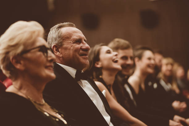 istock Smiling spectators sitting in the theater 1409455318