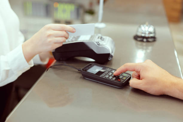 istock Guest at hotel reception paying with check during check-in 1409455567