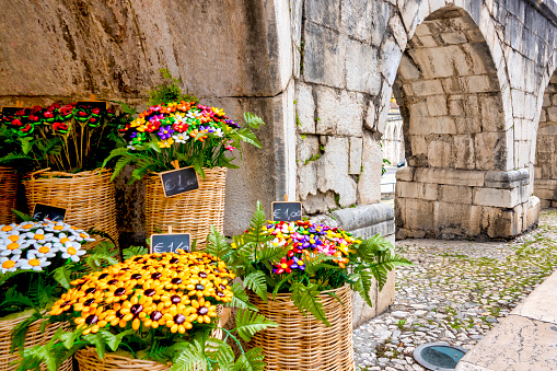 Confetti bouquet for sale under the arches of the Aqueduct Svevo, Sulmona, Italy