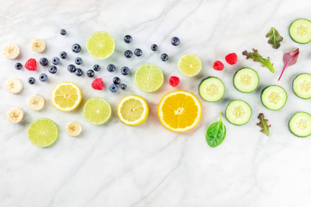 istock Fresh summer food. Fruit and vegetable slices, overhead flat lay shot 1409456764