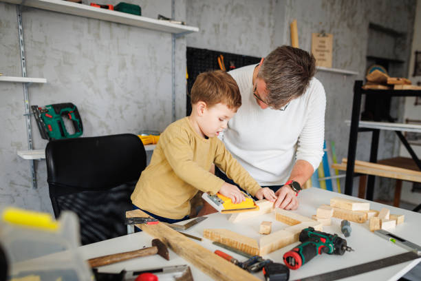 istock Father and son sanding wooden frame in carpentry workshop 1409458108