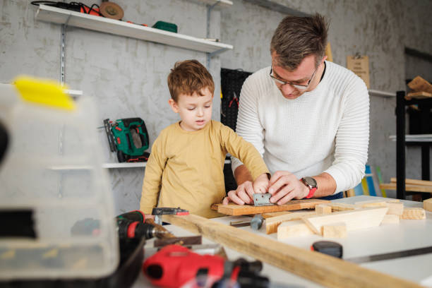istock Father and son working with wood in carpentry workshop 1409458151