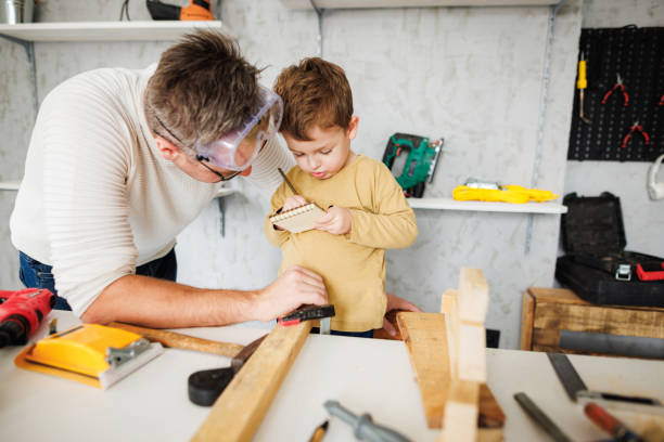 istock Little boy writing in notebook what father saying 1409458295