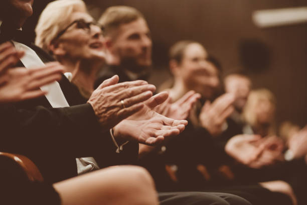 istock Spectators clapping in the theater, focus on hands 1409458442