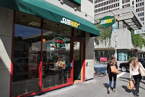 People walk by Subway sandwich store in San Francisco, California. Subway is a sub sandwich restaurant chain with over 37,000 locations worldwide.
