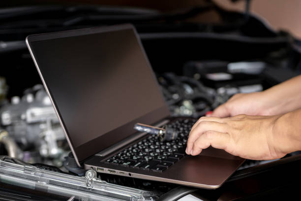 istock Car service and technology concept, Technicians use laptop check service lists for car part mistakes and maintenance in engine room 1409460172