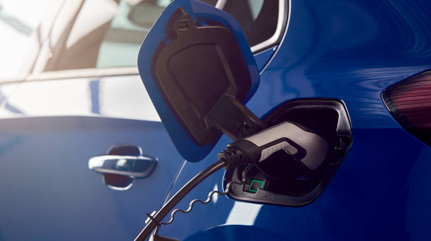 istock Charging Cable Attached To Environmentally Friendly Zero Emission Electric Car In Garage 1409460249