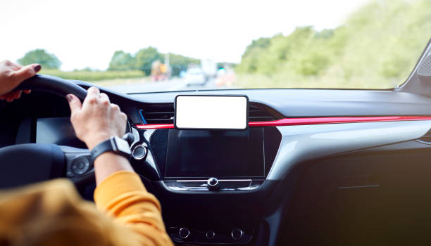 istock Close Up Of Driver With Hands Free Unit For Green Screen Mobile Phone Mounted On Dashboard 1409460307